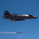 An early F-35A model undergoing testing in 2013, featuring the original major program partners’ flags on its side.